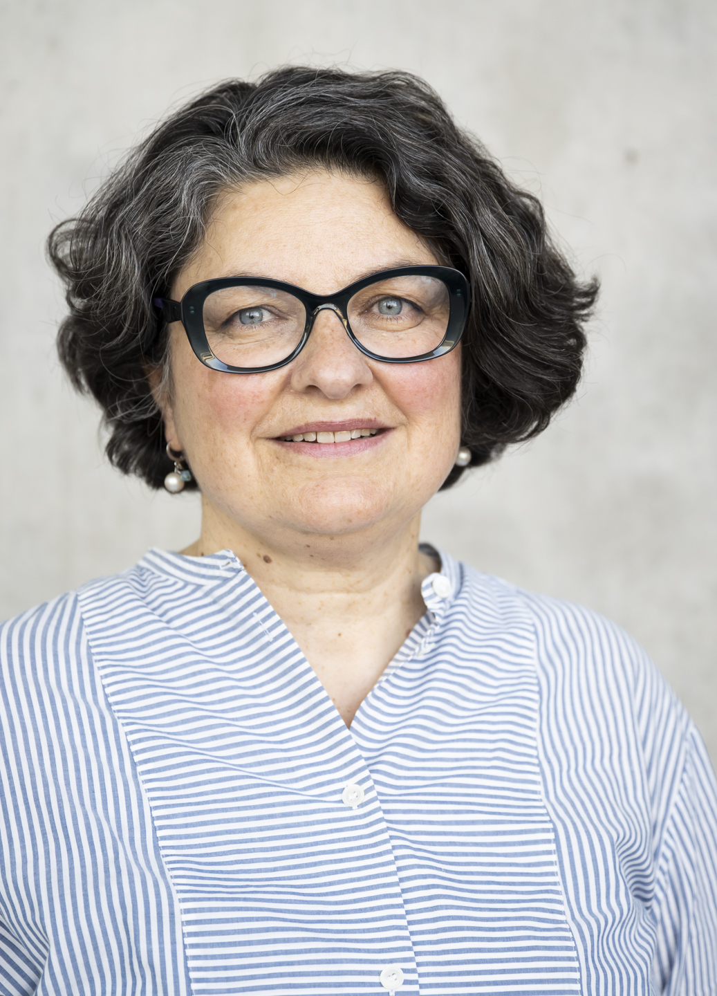 A person wearing glasses and a striped shirt
AI-generated content may be incorrect.